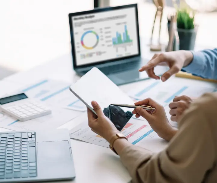 Business performance charts being analysed